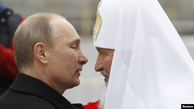President Vladimir Putin (left) welcomes Patriarch Kirill during a ceremony to mark National Unity Day in Moscow on November 4.