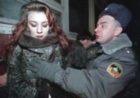 A policeman arrests a prostitute in Russia in 2001
