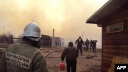 A firefighter and local residents battle a fire in a village in the Khakasia region in southeastern Siberia, earlier this week.