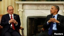 Burma's President Thein Sein (left) appears with U.S. President Barack Obama in the White House Oval Office in Washington on May 20.