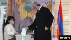 Armenian President Serzh Sarkisin casts his ballot during a referendum on constitutional changes in Yerevan on December 6. The proposals were passed with a large majority, but opposition groups say the vote was rigged.