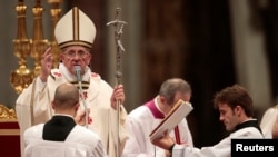 Roman Catholic Pope Francis issues blessings at the end of the Christmas night mass in the Saint Peter's Basilica.