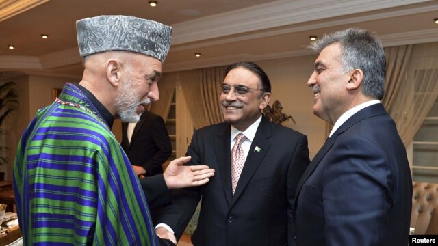 Presidents Hamid Karzai of Afghanistan, Asif Ali Zardari of Pakistan, and Abdullah Gul of Turkey (left to right) chat during a dinner at the Presidential Palace of Cankaya in Ankara.