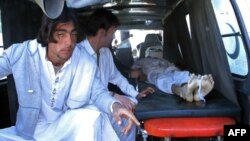Pakistani relatives transport the body of a blast victim to a hospital after an explosion at a market in Parachinar on December 13.
