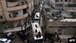 A Red Crescent convoy carrying humanitarian aid arrives in Kafr Batna, in the rebel-held Eastern Ghouta area, on the outskirts of the capital Damascus earlier this week.