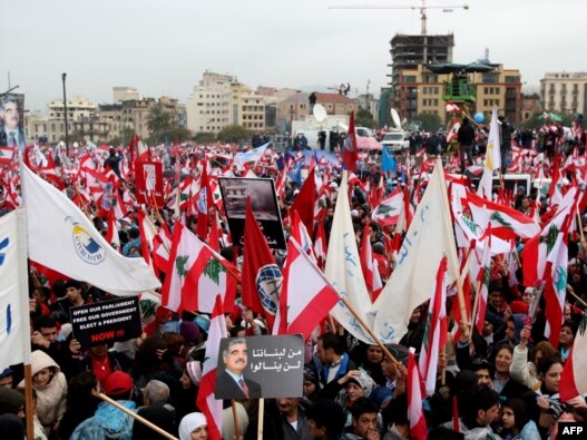 Lebanese wave national flags as they gather in February 2008 to commemorate the third anniversary of the assassination of Lebanese Prime Minister Rafiq Hariri.