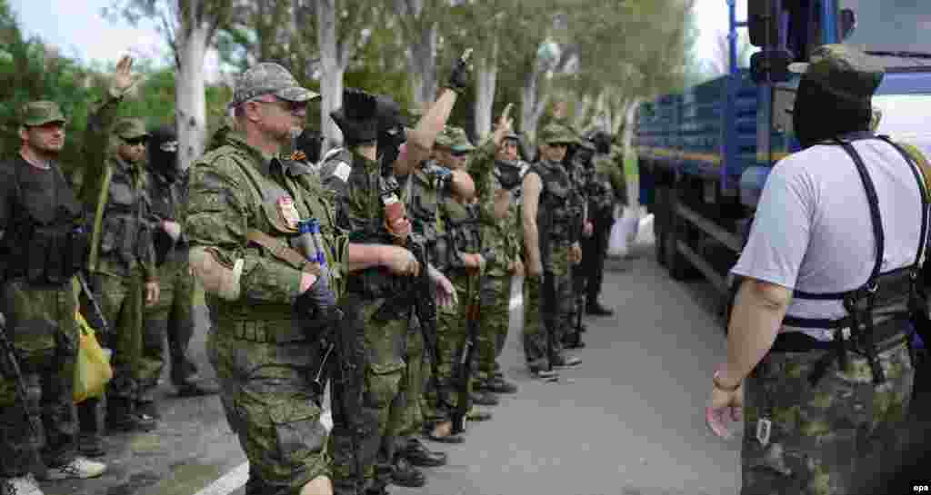 Pro-Russian separatists of the self-proclaimed "Vostok Battalion" preparing to board a truck at a checkpoint on the outskirts of the city of Donetsk on May 25.