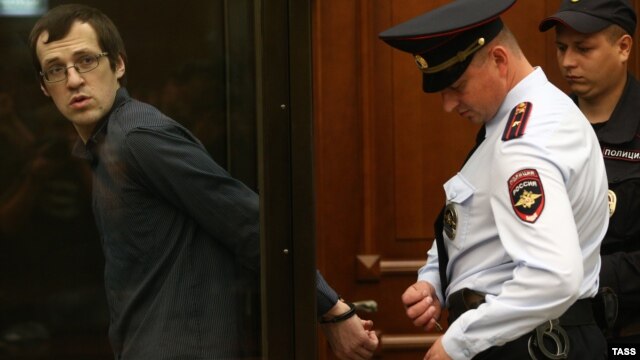 Leonid Kovyazin (left) appears in court for a hearing into the case over mass riots in Moscow's Bolotnaya Square during the opposition rally in May 2012.