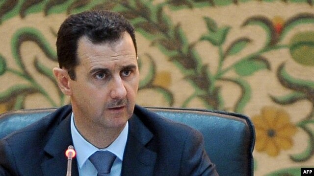 President Bashar al-Assad addresses his new cabinet during a swearing-in ceremony in Damascus on June 26.