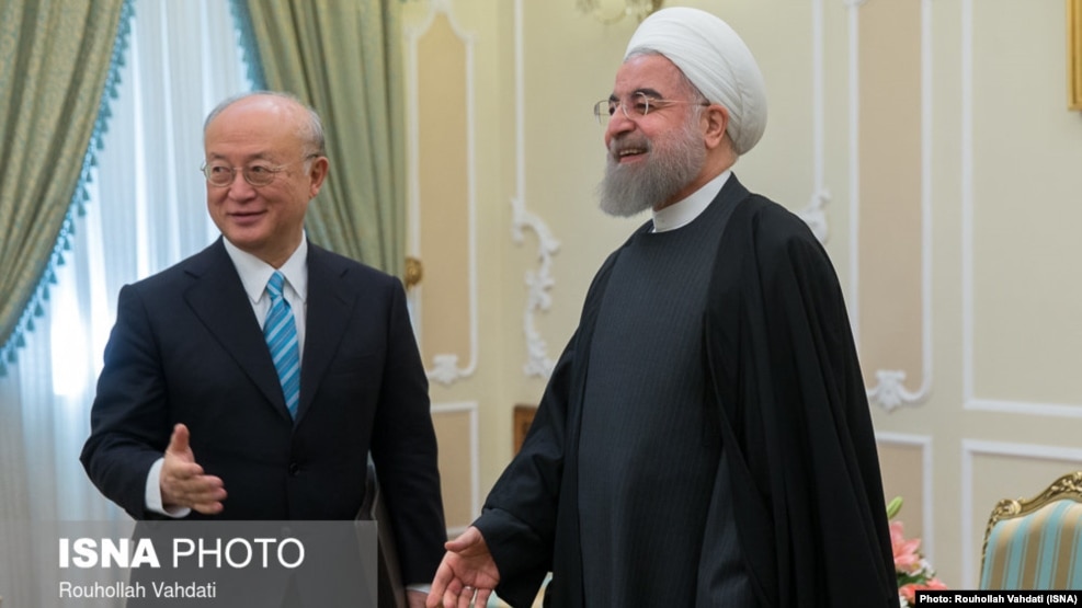 Iranian President Hassan Rohani (right) meets with UN nuclear chief Yukiya Amano in Tehran on December 18.