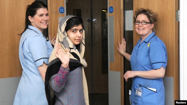 Pakistani schoolgirl Malala Yousafzai (center) waves with nurses as she is discharged from the Queen Elizabeth Hospital in Birmingham.
