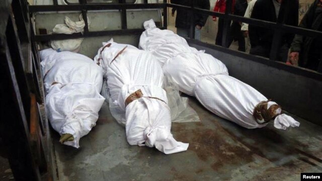 The bodies of what activists say are victims of shelling by the Syrian Army are seen in the Sunni district of Bab Amro in Homs on February 8.