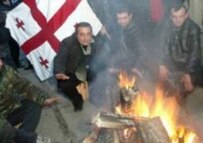 Georgians gather round a fire yesterday in Tbilisi (epa)
