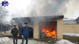Protesters set fire to a house
