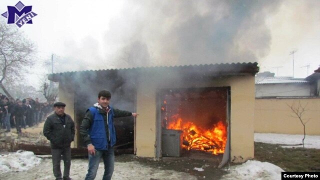 Protesters set fire to a house