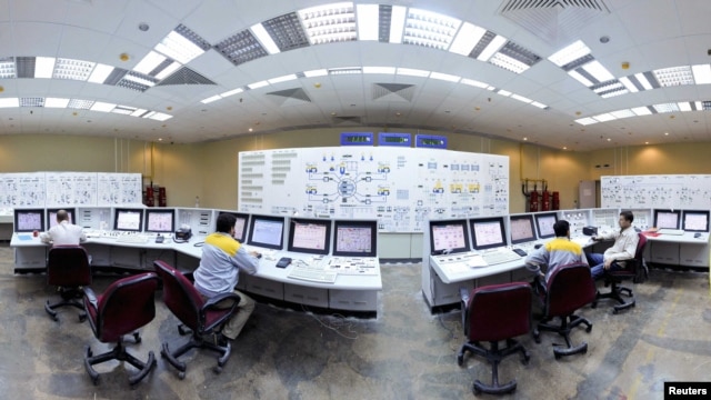 Russian and Iranian operators monitor the nuclear power plant unit at Bushehr.