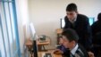 Students at a school in Azerbaijan peer at a computer monitor. (file photo)