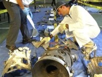 Weapons experts examine the remains of the missile in Tbilisi (AFP)