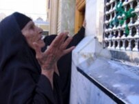 An Iraq Shi'a prays at the shrine of Imam Hussein on March 17 in Al-Karbala (epa)