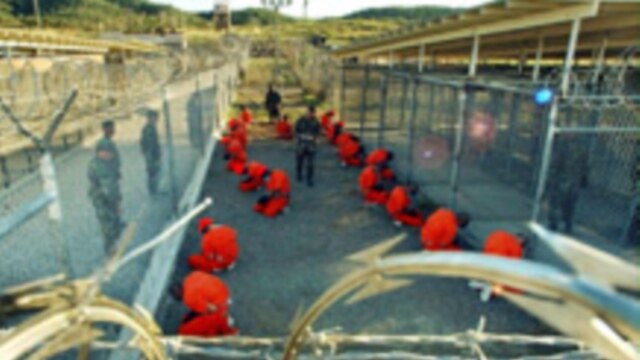 Detainees at Guantanamo Bay in a holding area under the eye of U.S. military police (epa)