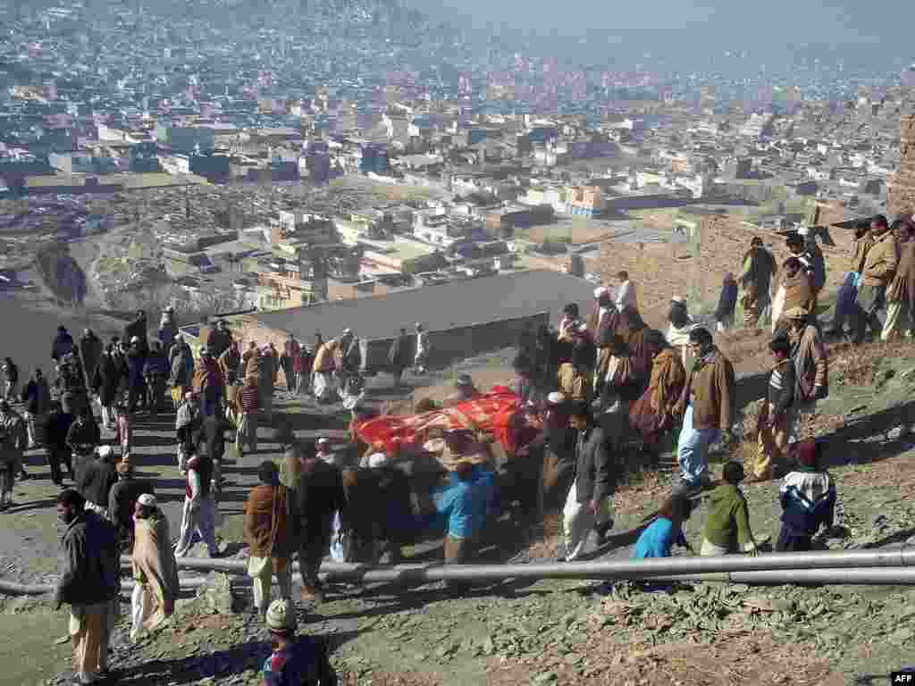 Local residents carry the coffin of a bomb blast victim during a funeral in Mingora. An explosion at a religious gathering in Pakistan's northwestern Swat Valley that killed 22 people and wounded more than 80 was caused by a bomb, officials said. (AFP)