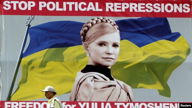 A man walks past a billboard with a portrait of jailed Yulia Tymoshenko in central Kyiv.