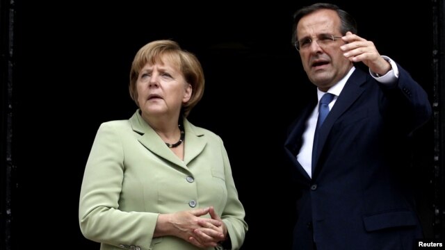 Greek Prime Minister Antonis Samaras talks with German Chancellor Angela Merkel in Athens.