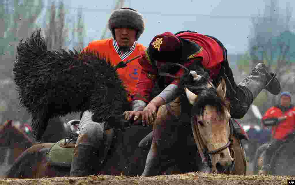 Mounted Kyrgyz riders play the traditional Central Asian sport of Kok-boru, aka Buzkashi or Ulak Tartis ("goat grabbing"), in Bishkek. (AFP/Vyacheslav Oseledko)