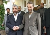 Larijani (right) with Hamas leader Khalid Mish'al in an undated file photo (Fars)