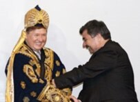  Tajik Energy Minister Jurabek Nurmakhmadov (right) helps Gazprom CEO Aleksei Miller put on Tajik national dress after signing a gas-development agreement in March (TASS)