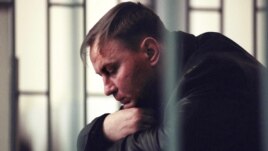 Colonel Yury Budanov sits in the defendant's box during his murder trial in Rostov-na-Donu in April 2003.