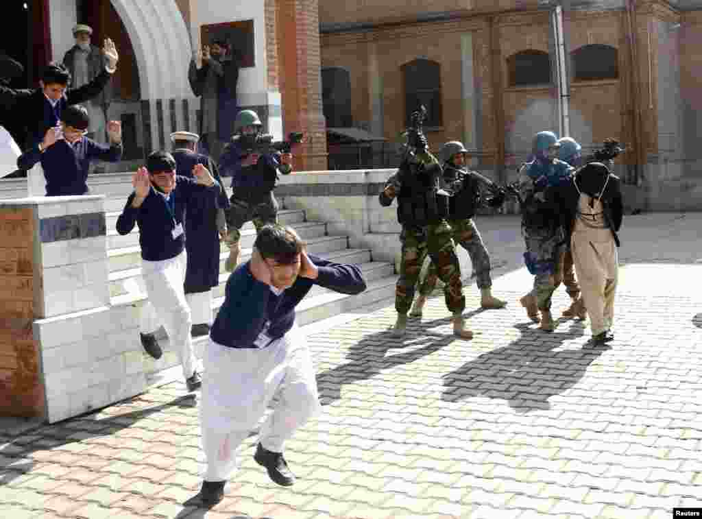 Schoolchildren flee as army soldiers conduct an mock counterterrorism exercise in Peshawar, Pakistan. (Reuters/Khuram Parvez)
