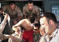 Spanish soldiers from the NATO-led international peacekeeping force carry a wounded Afghan soldier at their military base in Herat (file photo) (epa)