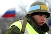A Russian peacekeeper guards a checkpoint outside the capital, Tskhinvali