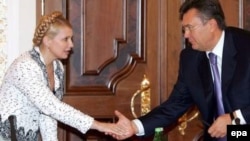 Jailed Ukrainian ex-Prime Minister Yulia Tymoshenko (left) talks with President Viktor Yanukovych in 2006.
