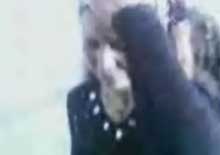 An unidentified woman turns from her attacker