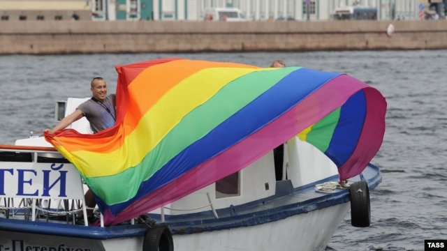An activist holds a rainbow flag during a gay pride event in St. Petersburg in June.