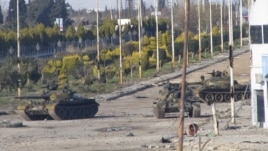 Syrian tanks are seen in Bab Amro near the city of Homs on February 12.