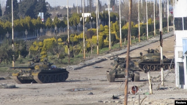 Syrian tanks are seen in Bab Amro near the city of Homs on February 12.