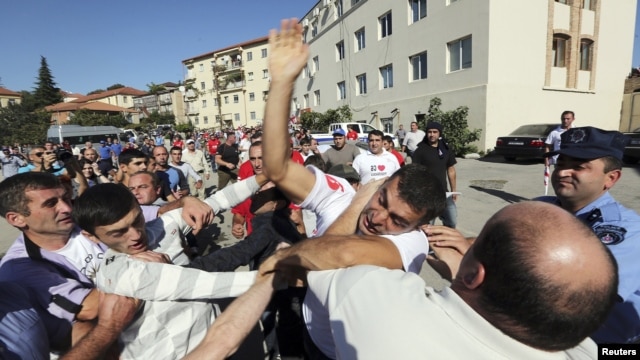 Supporters of the ruling United National Movement scuffle with supporters of the opposition Georgian Dream coalition during an election rally last week in the town of Signagi. Can the opposition consolidate a peaceful transition, and will the ruling party let them?