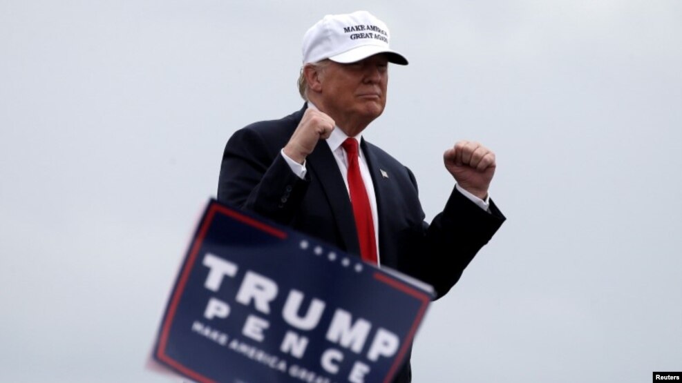 Republican U.S. presidential nominee Donald Trump reacts to cheers from supporters as he departs a campaign rally in Lakeland, Florida, on October 12.