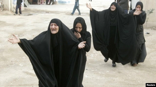 Women mourn during a funeral for a victim who was killed in one of the December 22 bomb attacks.