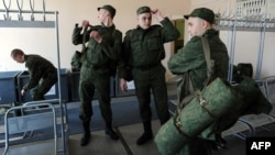 Russian Army conscripts put on their uniform at the military registration and enlistment office in St. Petersburg in April.