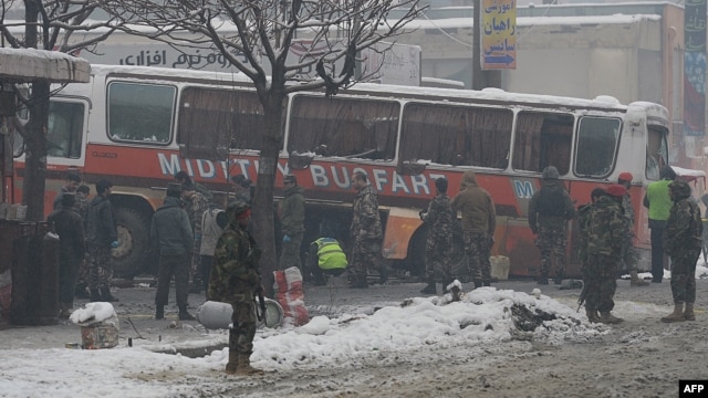 Afghan National Army soldiers investigate the scene following a suicide attack targeting a bus carrying Afghan army personnel in Kabul on February 27.