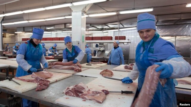 Belarusian workers prepare meat at a processing plant in Brest. 