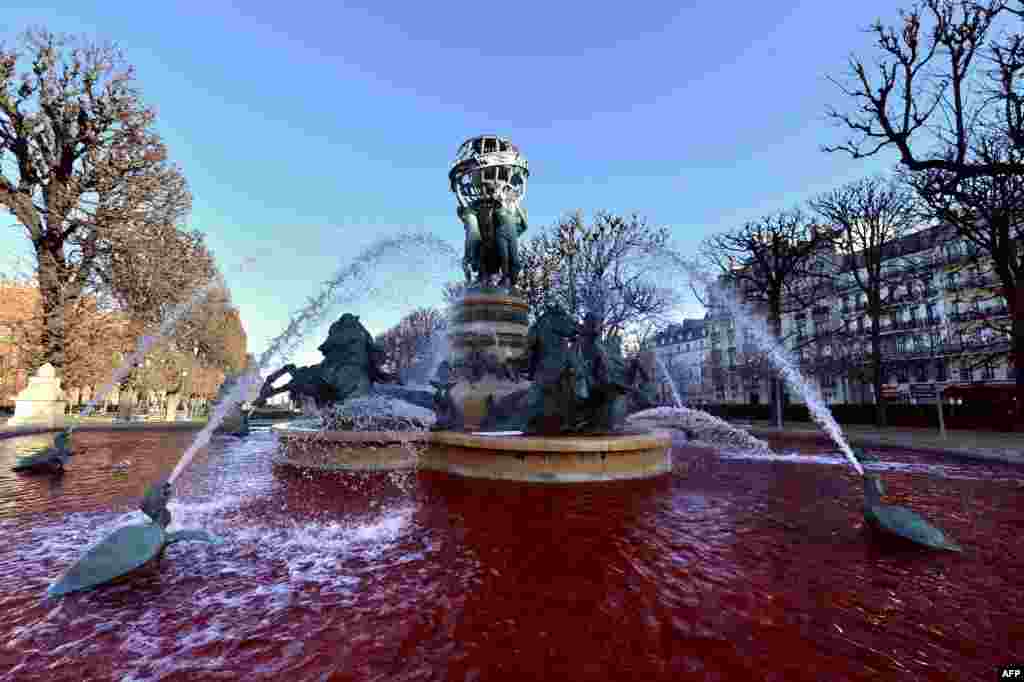 Red water looking like blood flows at the Nouvel Observatoire fountain in Paris after health-care professionals affiliated with the Le Bloc union poured red dye in many of the city's fountains to protest against the implementation of a new cooperative network scheme that they say would undermine the freedom to choose one's own doctor. (AFP/Miguel Medina)