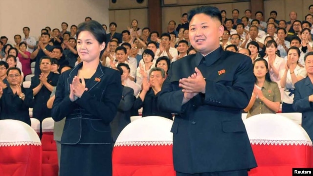 North Korean leader Kim Jong-Un (right) has been appearing in public with a mystery woman (left) in recent weeks. 