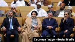 Muhiddin Kabiri (left) pictured with other conference delegates in Tehran on December 28.