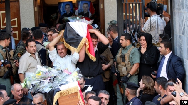 Christians carry coffins of their slain relatives during a funeral service at a church in Baghdad on November 2 for victims of the attack at the Assyrian Catholic Church of Our Lady of Salvation on the evening of October 31.