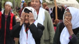 Torokul Doorov's winning photograph shows women offering their blessings at a circumcision celebration in Batken Region, Kyrgyzstan.